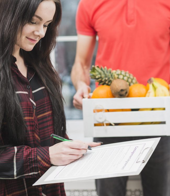 woman-confirming-fruit-delivery